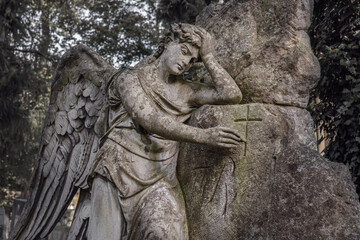 Wall Mural - Angel draws a cross on a stone. Old beautiful stone statue (faith concept)