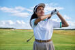 Waist up portrait of sporty black woman playing golf on field outdoors, copy space