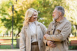 © LIGHTFIELD STUDIOS - Happy blonde woman looking at husband while spending time in park.
