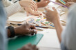 © winnievinzence - Background  hands drawing and painting tools on the table. color palette plate and paint brush. Arts class or home room activity at school