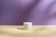 © gorina_anna - Empty white round podium and soft shadows on light purple and yellow background. Showcase for product presentation. Pedestal for beauty cosmetic branding. Minimal still life. Front view, copy space.