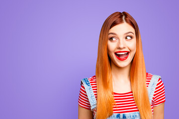 Canvas Print - Charming young girl delighted with the good news and now wide-open her mouth from surprise looks aside isolated on bright blue background with copy space for text