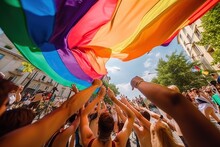 Many People Next To A Rainbow Flag Celebrate A Gay Pride Demonstration On The Street In Daylight. Homosexual, Pride, Protest, Crowd, Celebration And Diversity Concept. Image Generated With AI
