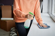 © Seventyfour - Close-up of young woman using detergent to do housework in her new apartment after relocation