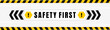 Safety first badge placed on gray background with black and yellow line striped. Attention label with Exclamation mark on hexagon. Vector illustration