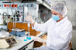 © JackF - Young woman scientist in a medical coat conducts experiments with liquids in the laboratory