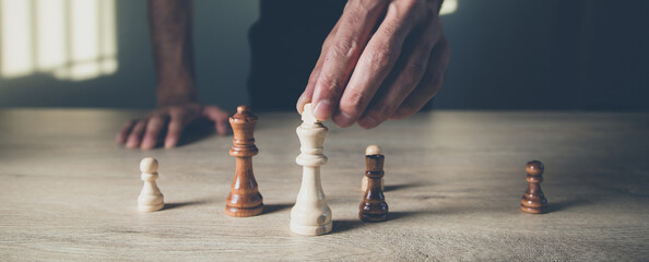 Wall Mural - man hand chess on the wooden  table