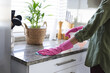© Wavebreak Media - Midsection of young caucasian woman spraying rubbing alcohol and cleaning countertop in kitchen