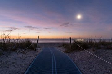 Wall Mural - Moon at sunrise on the beach