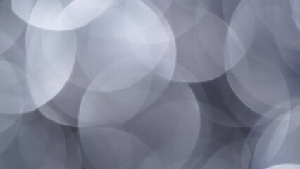 Wall Mural - Fading Overflow Of Large Silver Bokeh. Abstract movement of large defocused circles. Silver Bokeh Lights smooth motion with disappear. Light Leaks 4K moving background.