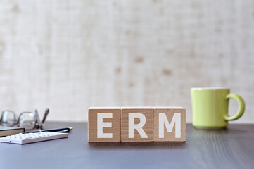 Poster - There is wood cube with the word ERM. It is an acronym for Enterprise Risk Management an eye-catching image.