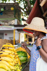 Wall Mural - Woman buying fruit with reusable cloth bags in supermarket