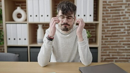 Sticker - Young hispanic man business worker stressed using laptop at office