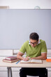 © Elnur - Young male student sitting in the classroom