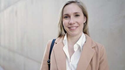 Sticker - Young blonde woman smiling confident standing at street