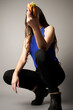 © Kelsie - Portrait of woman holding a hamburger in front of her face