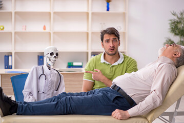 Wall Mural - Old male patient visiting skeleton doctor
