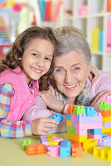 Poster - Cute girl and grandmother playing