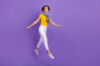 © deagreez - Full length photo of cheerful glad adorable lady moving empty space enjoy walk free time good mood isolated on purple color background