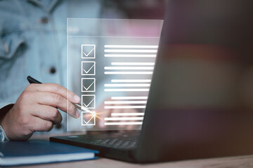 Poster - Business performance checklist concept, businessman using laptop doing online checklist survey, filling out digital form checklist. Business performance monitoring concept, digital form checklist.