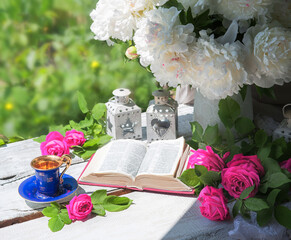 Wall Mural - Book and coffee near a bouquet of flowers