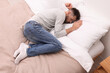 © New Africa - Upset man lying on bed. Loneliness concept