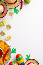 Top Vertical View Photo Of Cinco De Mayo Accessories Sombrero Tequila Shots Lime Plate With Nacho Chips With Salsa Sauce Maracas On White Backdrop With Copyspace
