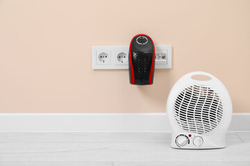 Wall Mural - Modern electric compact and fan heaters indoors, space for text