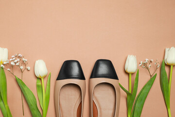 Poster - Flat lay composition with pair of new stylish square toe ballet flats and beautiful flowers on beige background. Space for text