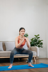 Asian Woman Doing Yoga and Watching Online Tutorials on Laptop, Training in Living Room