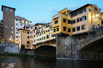 Wall Mural - Detail of Ponte Vecchio seen from a boat on the Arno River in Florence, Tuscany, Italy