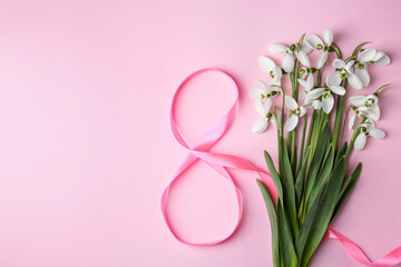 Wall Mural - Beautiful snowdrops and number 8 made of ribbon on pink background, flat lay. Space for text