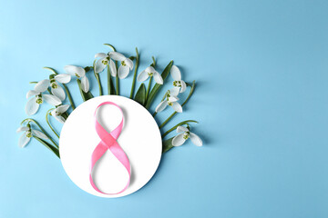 Wall Mural - Beautiful snowdrops, paper card and number 8 made of ribbon on pink background, flat lay. Space for text