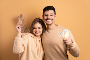 Wall Mural - cheerful couple celebrating successful business money in studio shot. economy, payment, successful concept. 