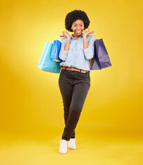 Poster - Black woman with shopping bag, smile with fashion and retail in portrait on yellow studio background. Happiness, female with discount and sale at boutique with designer brand, happy and mockup space