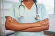 © Meeko Media - Cropped close up of doctor's arms folded holding stethoscope modern office