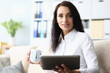 © H_Ko - Portrait of a beautiful woman with tablet and cup on sofa