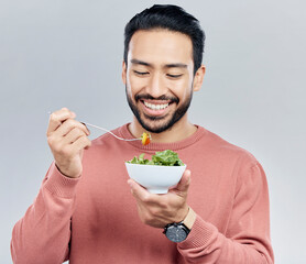 Sticker - Man, salad food and eating healthy in studio for health or wellness motivation for vegetables. Asian male happy with vegetable for nutrition, diet and benefits to lose weight on a white background