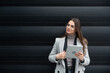 © Srdjan - Portrait of young businesswoman outside the office building expert in global business and marketing, employee of a company for sale of stock shares and telecommunications. Successful business person