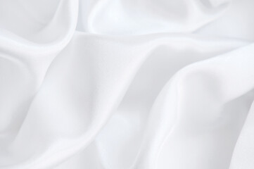 background of white silky fabric with soft waves