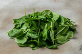 Fototapeta Tematy - Fresh green spinach. Healthy leafy vegetables on the table. Food recipe background. Close up