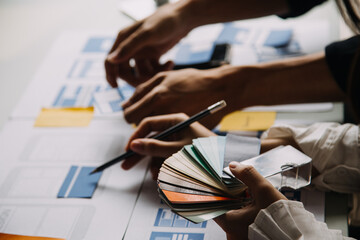 Close up ux developer and ui designer use augmented reality brainstorming about mobile app interface wireframe design on desk at modern office.Creative digital development agency