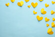 Paper-cut yellow hearts on blue background. Love, romantic concept. Creative layout. Top view. Copy space