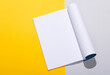 Mockup of open magazine with white open page on a gray yellow background. Template for design