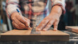 Close-up of hands of carpenter woman drawing mark on wood with ruler and pencil. DIY concept