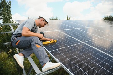 Wall Mural - Worker installing solar panels outdoors