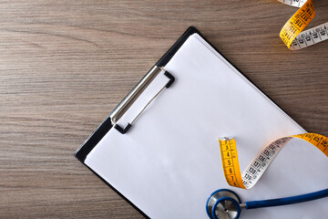 Wall Mural - Notebook for body control with stethoscope and meter on table