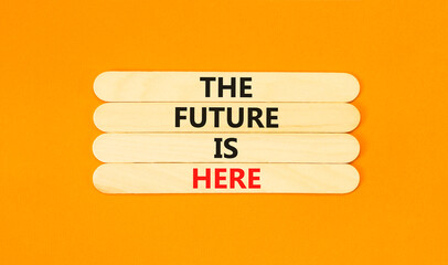 Wall Mural - The future is here symbol. Concept words The future is here on wooden stick. Beautiful orange table orange background. Motivational business the future is here concept. Copy space.