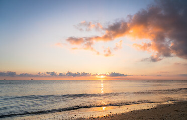 Wall Mural - Sunset on the beach with clouds