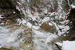 A waterfall viewed from above. This waterfall is located in Cuyahoga Valley National park. It is a cold winter day, and snow covers the hemlock and other evergreens nearby.
